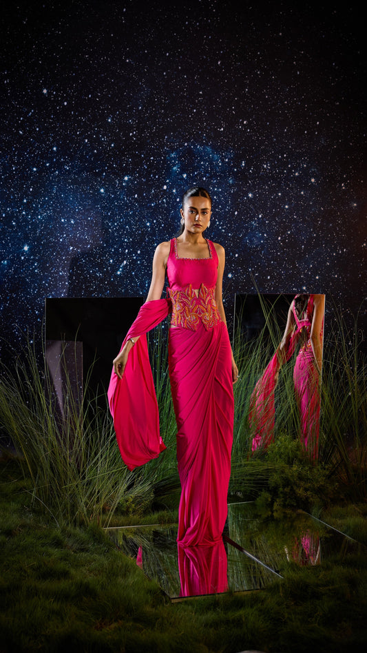 Woman in a bright pink saree with a starry night sky background